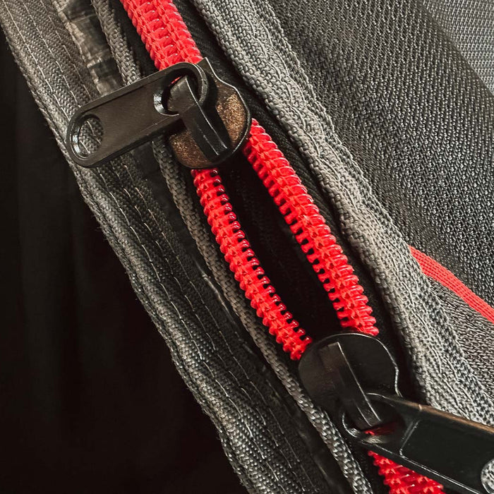Close up of a a repaired zip on a board bag