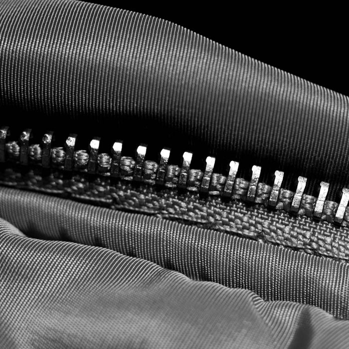Close-up of a zipper on sports fabric with a black background